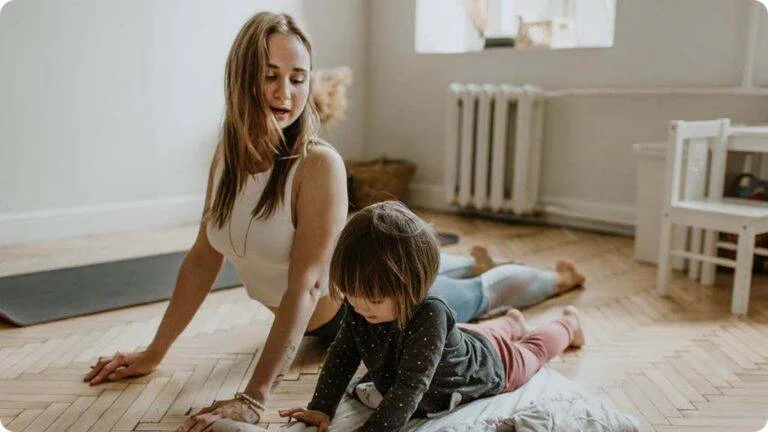 Woman-doing-yoga-with-daughter - Hobbies for stay at home mums