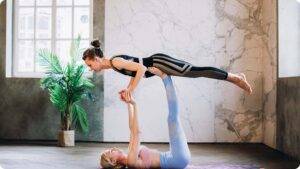 Two women Doing Yoga - Physical Flexible Activities