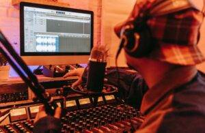 How to become a music producer - A man making beats at a studio
